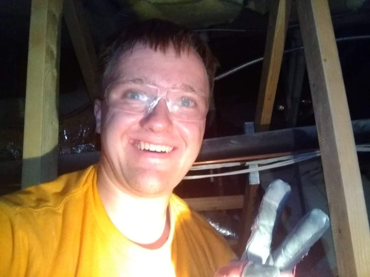Technician in the attic during guano cleanup and remediation work